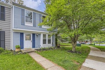 Columbia house for rent - a blue house with a sidewalk and trees in front of it