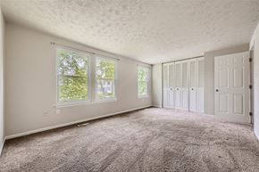 Columbia house for rent - an empty living room with carpet and white doors
