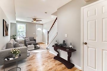 Baltimore house for rent - A living room with a grey couch and a wooden table.