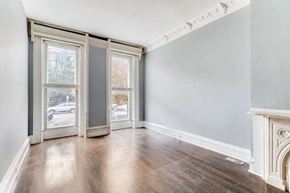Baltimore apartment for rent - an empty living room with wood floors and a fireplace