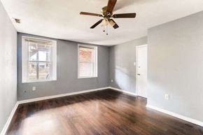 Baltimore apartment for rent - an empty living room with a ceiling fan
