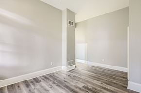 Baltimore apartment for rent - A room with wooden flooring and white walls.