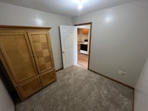 Vaughnsville apartment for rent - A room with a wooden cabinet and a doorway leading to another room.