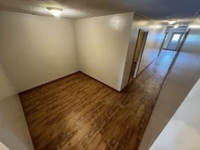 Vaughnsville apartment for rent - A room with wooden flooring and white walls.