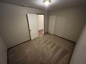 Vaughnsville apartment for rent - A room with carpeted floor and two doors.