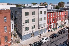 Philadelphia apartment for rent - A street view of a city with cars and buildings.