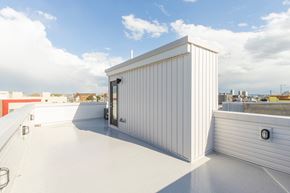 Philadelphia apartment for rent - a small shed on the roof of a building with a city in the background