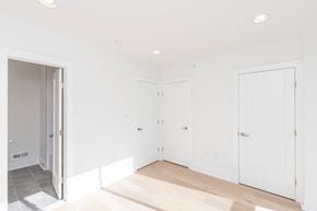 Philadelphia apartment for rent - a bedroom with white walls and white doors and a wood floor