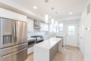 Philadelphia apartment for rent - a white kitchen with stainless steel appliances and white counter tops