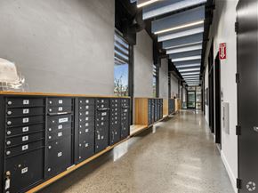 San Jose apartment for rent - A long hallway with a series of lockers on the left and doors on the right.