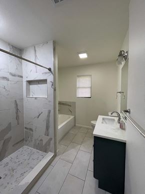 Killeen house for rent - a bathroom with a shower and a sink and a tub