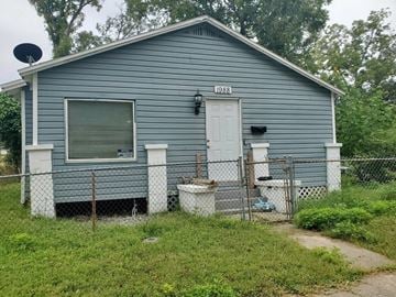 Jacksonville house for rent - a blue house with a fence and a white door