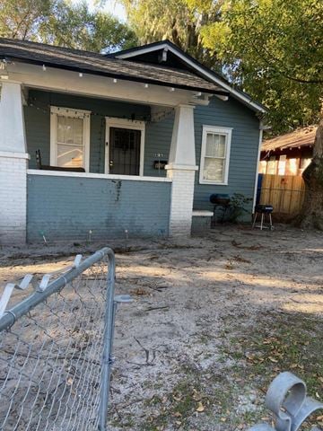 Jacksonville house for rent - an empty yard in front of a blue house with a fence