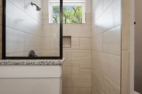 Spring Branch apartment for rent - the bathroom has a large mirror and a shower with a window