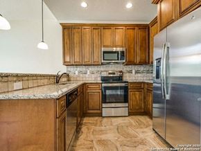 Spring Branch apartment for rent - a kitchen with wooden cabinets and stainless steel appliances