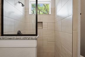 Spring Branch apartment for rent - the bathroom has a large mirror and a shower with a window