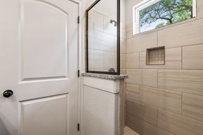 Spring Branch apartment for rent - a small bathroom with a shower and a white door