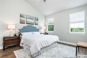 Spring Branch apartment for rent - a white bedroom with a bed and two windows