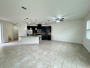 Orlando house for rent - an empty kitchen and living room with a ceiling fan