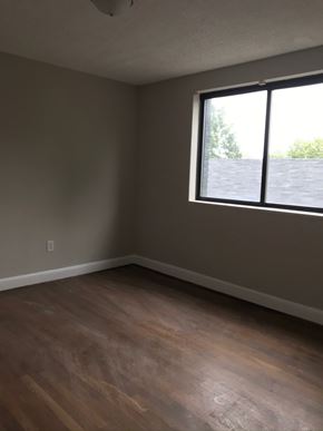 Washington apartment for rent - an empty room with a window and wooden floors