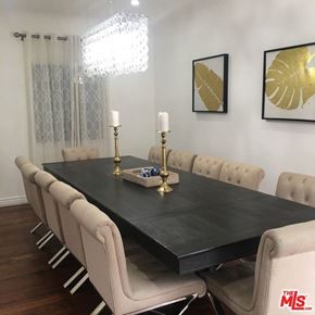 Los Angeles house for rent - a dining room table with chairs and a chandelier