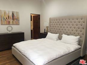 Los Angeles house for rent - a bedroom with a bed and a dresser and a painting