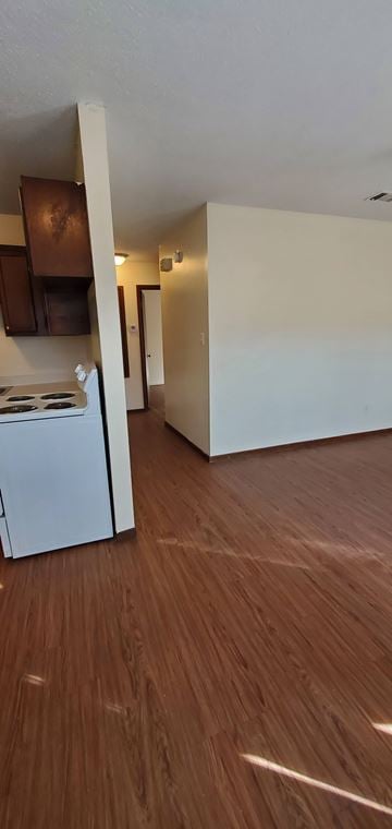 Hattiesburg apartment for rent - A kitchen with white appliances and wooden floors.