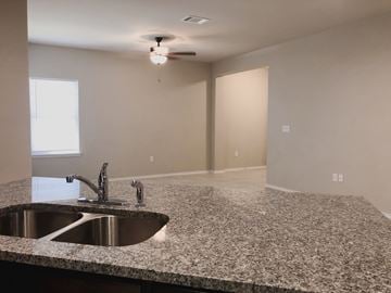 Georgetown triplex for rent - A kitchen counter with a sink and a fan on the ceiling.