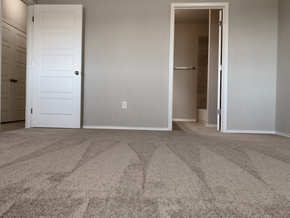 Georgetown triplex for rent - A carpeted room with two doors, one of which is open.