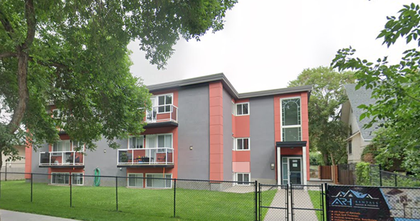 Edmonton apartment for rent - an apartment building with a fence in front of it