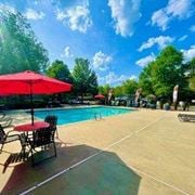 Morrow apartment for rent - a swimming pool with tables and umbrellas at Hidden Creek, Morrow, GA
