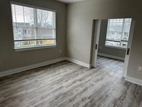 Hickory apartment for rent - an empty living room with wood floors and two windows