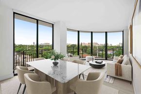 Miami apartment for rent - A dining room with a table and chairs and a view of the city.
