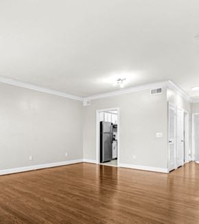 Nashville apartment for rent - A kitchen with a refrigerator and wooden floors.