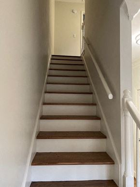 Nashville apartment for rent - A staircase with white walls and wooden steps.