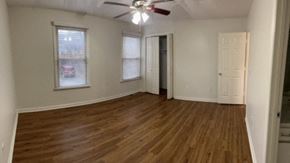 Nashville apartment for rent - A room with wooden floors and a ceiling fan.