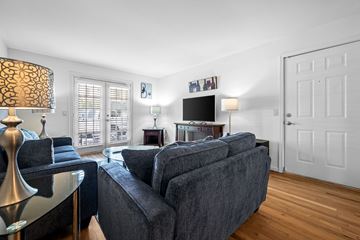 Nashville apartment for rent - A living room with a grey couch and a black and white lamp.