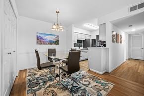 Nashville apartment for rent - A dining room with a table and chairs and a painting on the wall.