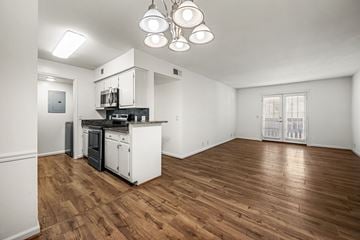 Nashville apartment for rent - A kitchen with white cabinets and a wooden floor.