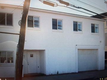 Salisbury apartment for rent - A white building with a closed garage door.