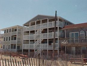 Salisbury apartment for rent - a beach house with a wooden fence in front of it