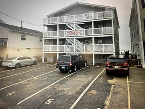 Salisbury apartment for rent - a beach house with cars parked in front of it