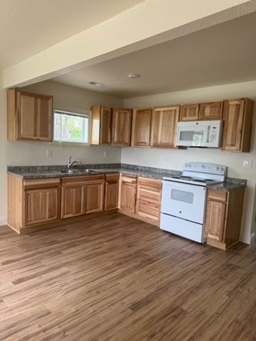 Billings house for rent - A kitchen with wooden cabinets and a white oven.