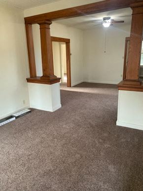 Allentown house for rent - an empty living room with carpet and a ceiling fan