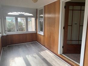 Allentown house for rent - an empty room with wood paneling and a window