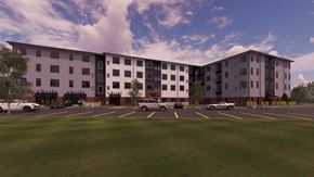 Royersford apartment for rent - A large building with a parking lot in front of it.