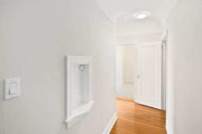San Francisco apartment for rent - a living room with white walls and a door to a hallway