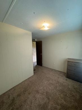 Boonville house for rent - A room with a carpeted floor and a door in the background.