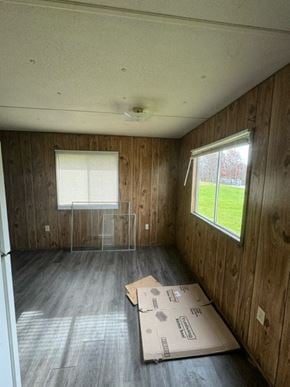Boonville house for rent - A room with wooden walls and a window with blinds.