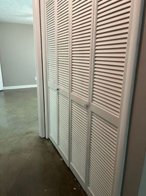 Newnan house for rent - Closed white shutter doors in a room.